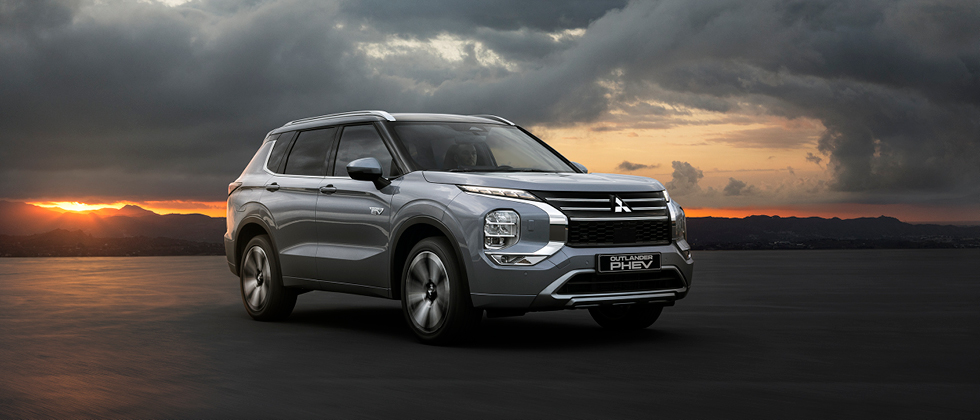 Mitsubishi Outlander med en solnedgång i bakgrunden